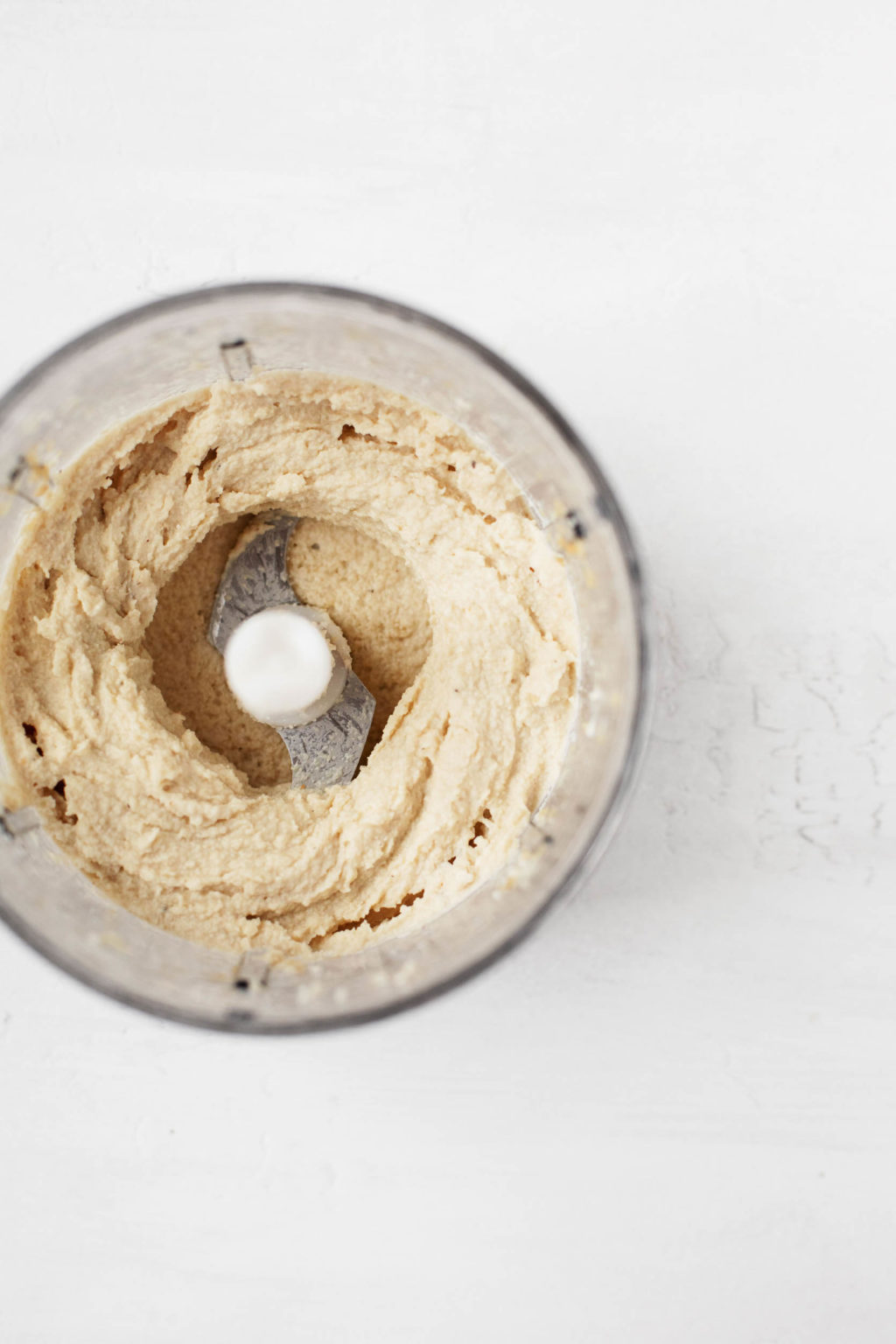 Cashews have been whipped into a creamy, spreadable mixture in a food processor.
