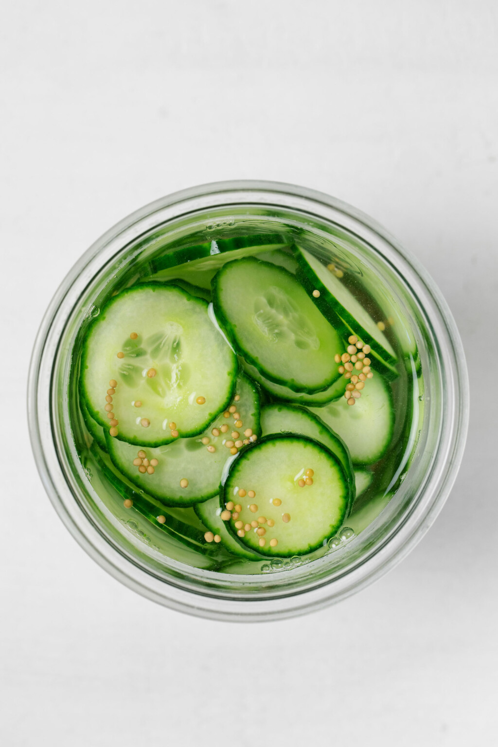 https://www.thefullhelping.com/wp-content/uploads/2023/06/pickled-cucumber-slices-2-1024x1536.jpg
